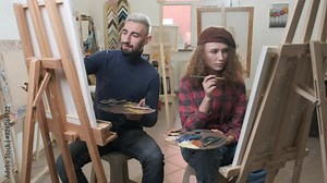 Man and woman are focused drawing the paintings Stock Video