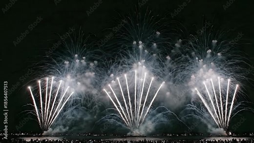 Epic Fireworks Display Over Water with Large Crowd at Night