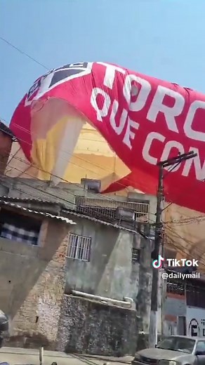 This is the moment a blimp crashed into a row of houses, injuring one person. The airship was rented by Brazilian soccer team São Paulo FC for a promotion and was performing a test flight when it suddenly plummeted. Footage showed the blimp on top of the homes as curious residents rushed out of their homes. The pilot, whose name has not been released, was rescued from the cabin and taken to a local hospital. Authorities have not said if any people were inside the homes at the time of the acciden