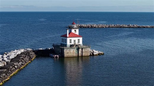 A beacon on the lake, a symbol of guidance. The West Pierhead Lighthouse reflects what college can be at SUNY Oswego: steady support as students chart their own path forward. 🌊✨ #FlyoverFriday | SUNY Oswego
