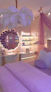Clean girl cozy room tour but make it ✨princess edition✨ 💜 This space feels like a soft, glowing dream — warm fairy lights, blush and lavender tones, fluffy textures, and the prettiest vanity setup ever. From the floral mirror moment to the glowing shelves, dreamy neon sign, and that cozy bed layered with plush pillows… every corner is giving calm, feminine, main-character energy 🌙🕯️ It’s the kind of room where you do your skincare slowly, journal at night, and romanticize your whole life 💕 