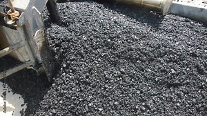 Asphalt paver machine working on the road construction site