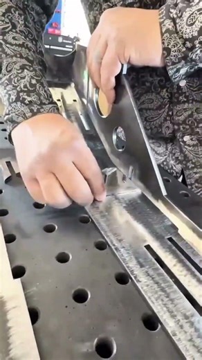 assembling metal parts on perforated table for precise welding and manufacturing of steel structure