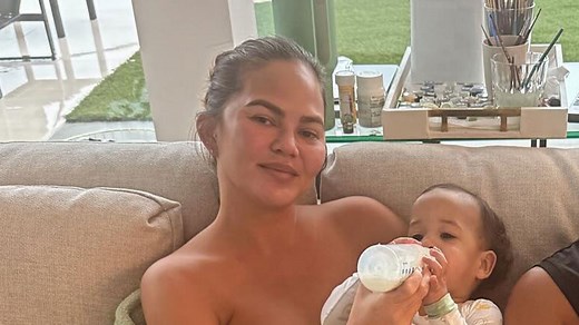 Chrissy Teigen suffers wardrobe malfunction while topless at home