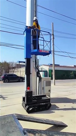 Worker on hydraulic lift performing safe maintenance work