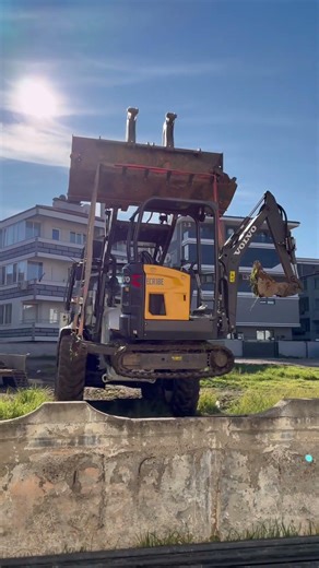 Backhoe Loader rescuing mini excavator from backyard space