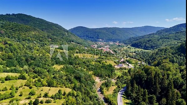 Vast landscape overlooking the Prahova Valley. The view extends far into the distance showing the town below.
