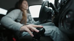 Closeup of female driver changing gears with manual transmission gear...