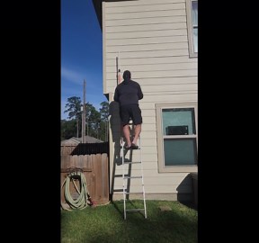 Man struggles to hang lights as his ladder begins to tremble under him