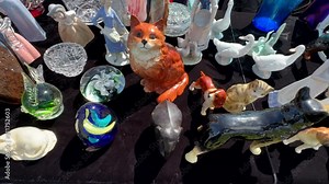 Close up of bric-a-brac items at flea market, handheld camera shot.