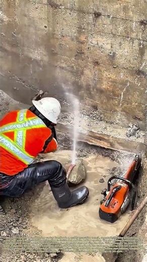 Hammering a Burst Pipe: How a Worker Uses Force to Seal a Leaking Water Line