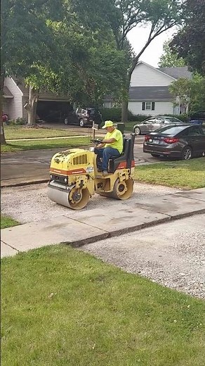 Road Roller Compactor Smooths A Driveway