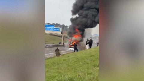 Dramatic moment fire engulfs bus full of soccer fans on UK highway
