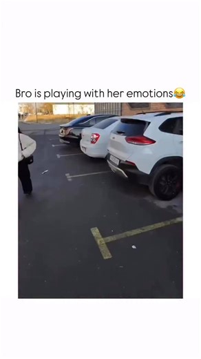 Sarcasm wrrld on Instagram: "In this video, a young woman is walking down a sidewalk alongside a parking lot when she is approached by someone holding out a closed fist, as if offering a surprise. Initially, she appears hesitant and confused, even covering her ears at one point as if trying to block out the interaction. However, as the person continues to gesture, she decides to play along and taps the hand. Upon her tap, the hand opens to reveal a small snack or treat. This interaction repeats