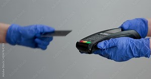 Credit card machine for money transaction. Woman hand in gloves with credit card swipe through pos terminal and enter pin code. Banking services of electronic money. Financial success and safety