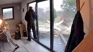 In Falkirk, Scotland, this man was working in his office when Storm Eowyn hit. The storm blew the roof off his neighbor’s garden room, sending it flying over 250 feet. It smashed into the man’s office, leaving him shocked by the sudden crash. | Jukin Copyright Management | Facebook