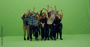GREEN SCREEN CHROMA KEY Front view group of young people dancing and jumping with hands in the air. 4K UHD ProRes 4444