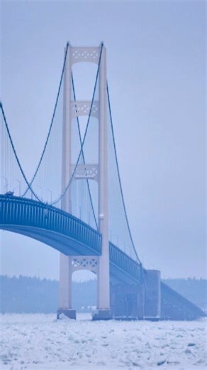 February 11th on the frozen Straits of Mackinac 🌫️❄️ The Mighty Mac rises through thick winter fog, standing timeless and unbreakable over ice-covered waters. You feel incredibly small out here—this is Pure Michigan at its most magical. Who else gets chills seeing the bridge disappear into the mist like this? 👇 #PureMichigan #MackinacBridge #MightyMac #MichiganWinter #UpperPeninsula | All About • Michigan