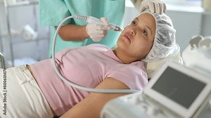 Cosmetic doctor confidently uses Hydrogen Oxygen Hydrating attachment to enhance moisture and maintain youthful appearance of client's skin.