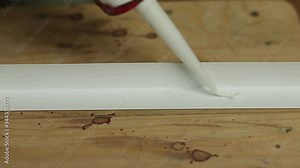 Corner for a window sill. Apply mounting glue to the plastic corner. Sealant and plastic corner.