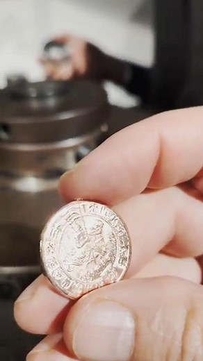 Minting of a copper token at the Money Museum in Hall, Tyrol