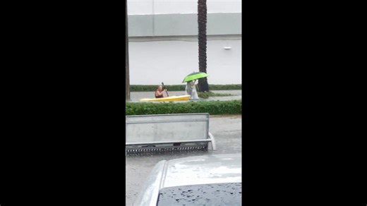 Man Kayaking on Flooded Street