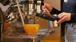 Barista girl makes coffee cup on espresso machine in a cafe bistro at the morning