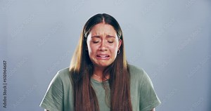 Sad, face and woman with tears in studio with a broken heart after breakup, divorce or bad news. Emotion, upset and portrait of female person crying for grief, loss or bereavement by gray background.