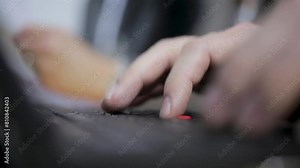 Close-up of hands typing rapidly on a laptop keyboard, focus on fingers and keys