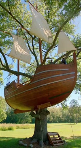Construction of a treehouse shaped like a vintage pirate ship.