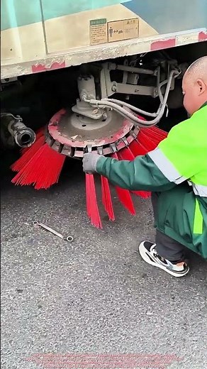 Sanitation Worker Replacing Worn Nylon Brushes on Street Sweeper Brush Head