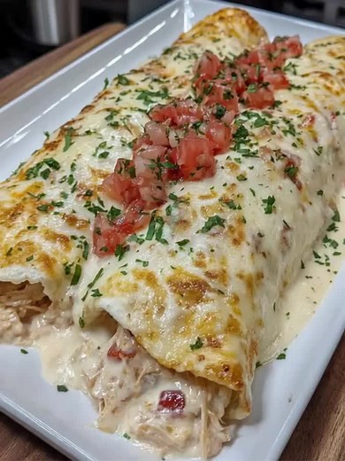 #Creamy #Queso #Chicken Enchiladas 🌮🧀 Tender chicken #enchiladas smothered in creamy queso blanco and melty cheddar for bold #Tex-Mex flavor. Made with simple ingredients, this easy comfort dinner is perfect for busy family nights. Ingredients: 5 Burrito Size Flour Tortillas 2 ½ cup Shredded Chicken ½ Packet Taco Seasoning 1 cup Sour Cream 1 cup Cheddar Cheese shredded 2 tablespoons Chopped Green Chilies 10 ounces Diced Tomatoes with Green Chilies undrained 1 pounds Queso Blanco Velveeta cubed