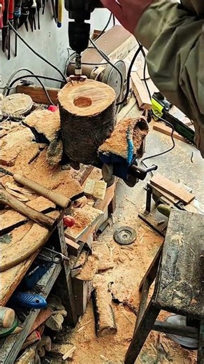 Hollowing tree trunk with drill on workshop bench