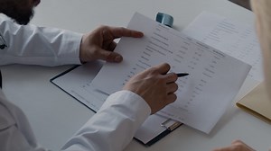 Doctor reviewing a medical report | Free Stock Video Footage