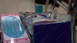 Health and Medical : Blood bag in collection mixer machine for blood donor at donation. Blood donation occurs when person voluntarily has blood drawn used for transfusions.