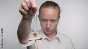 Woman hypnotist with hypnotic pendulum in hand in hypnosis session. Stock Video