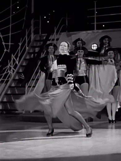 Eleanor Powell seen here performing a “Cape Dance” accompanied by Tommy Dorsey and his Orchestra in 1942’s “Ship Ahoy”.With a preference toward ballet and acrobatics (notably her splits), Powell did not initially tap in her early career. In fact, she disliked the style which she considered lacking in grace. It was only when she lost a number of musical roles in New York because she could not tap that she realised the need to learn.Due to her aerial style, she was taught to tap by being forced to