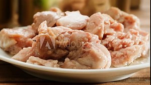 Canned tuna or cod fish on plate close-up macro. Canning delicious fish in olden and silver cans with pull rings. Canned tourist food and fish or wet pet food, pate