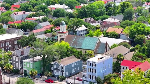 Aerial view of stunning houses in neighborhood landscapes of coastal Charleston, South Carolina downtown skyline showcasing lowcountry metropolitan scenery - 4K Drone