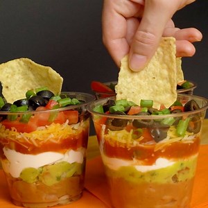 These INDIVIDUAL SEVEN LAYER CUPS are always a hit wherever I take them!! PRINTABLE RECIPE HERE: http://therecipecritic.com/2012/06/individual-seven-layer-dip/ | The Recipe Critic