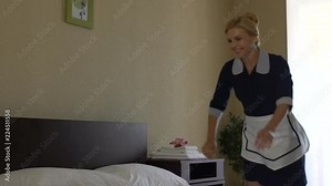 Funny maid jumping on huge bad of luxury hotel suit, cozy orthopedic mattresses