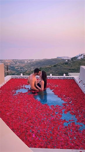 💋 Couple's Fantasy Page 💋 on Instagram: "Welcoming the New Year wrapped in love, floating in a swimming pool filled with soft rose petals, where every ripple carries a promise of forever. As the mountains stand silent like old guardians, watching over us, the sunset melts the sky into shades of gold, pink, and fire. In this moment, time slows down—just hearts beating in sync, water shimmering with love, and petals dancing around us like blessings. The cool mountain breeze, the warmth of your p