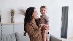 Loving mother cradles son in arms, their eyes meeting in a world of shared affection and understanding. Conversation flows with love and tenderness, filling the room with the warmth of bond.