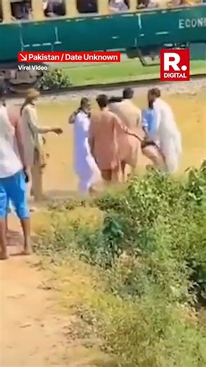 A viral video making waves online, shows a dangerous prank by young men in Pakistan town. The incident highlights the growing concern over reckless behavior fueled by social media.The viral video shows the Pakistani men positioning their motorcycle near a shallow puddle beneath train tracks. Their idea of fun is to drench a passing train with water for a “funny” moment. . . . #Pakistan | #Viral | #Viralvideo | #Movingtrain | #Train #Pakistani | #RepublicTV | #Republicworld | Republic