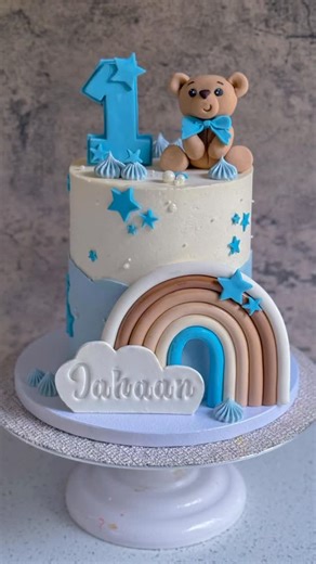 Ankita Dutta Dubey | CAKE ARTIST on Instagram: "I was really bummed when I saw the video later and it was a bit blurry. But the cake is really cute and I wanted to put it out there 😌 Would you believe me if I told you that this buttercream is eggless! 😎 If you are wondering how I stick the rainbow to the cake - I put some buttercream behind the rainbow to stick it and edible glue at it feet to stick it to the cake board. That rainbow ain’t going no where. And of course sharing my old and teste