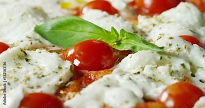 Super slow motion of a middle aged chef cutting mozzarella of bufala cheese for pizza on a restaurant kitchen table in 4k (close up)