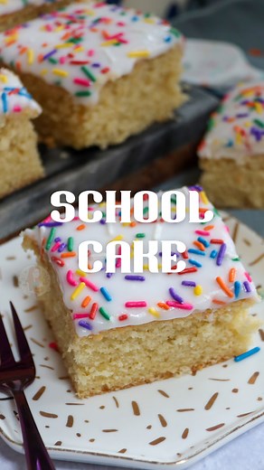 School Cake 😍🌈 Such an iconic nostalgic and classic bake! A simple vanilla sponge cake topped with water icing and sprinkles - it’s delicious, it’s easy to make and it looks great! I love mine served with a generous helping of custard! 😋 What’s your favourite classic bake? Let me know in the comments! Find the full recipe on my blog here - https://www.janespatisserie.com/2021/08/21/school-cake/ | Jane's Patisserie