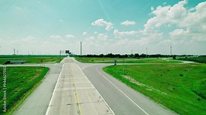 Raising aerial above Interstate 65 sign and many semi trucks on highway. Critical Driver Shortage Impact concept.