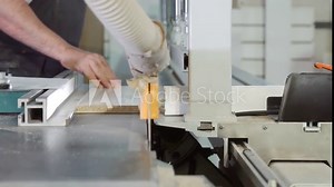 Furniture manufacture. The sawing process of the chipboard by a circular saw. Cutting the chipboard on the machine.