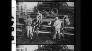 1986 Ukraine. Soldier in gas mask respond to the Chernobyl disaster. Decontamination of hazardous materials spraying of military trucks, washing and scrubbing of cows. 4K Overscan of Archival Newsreel